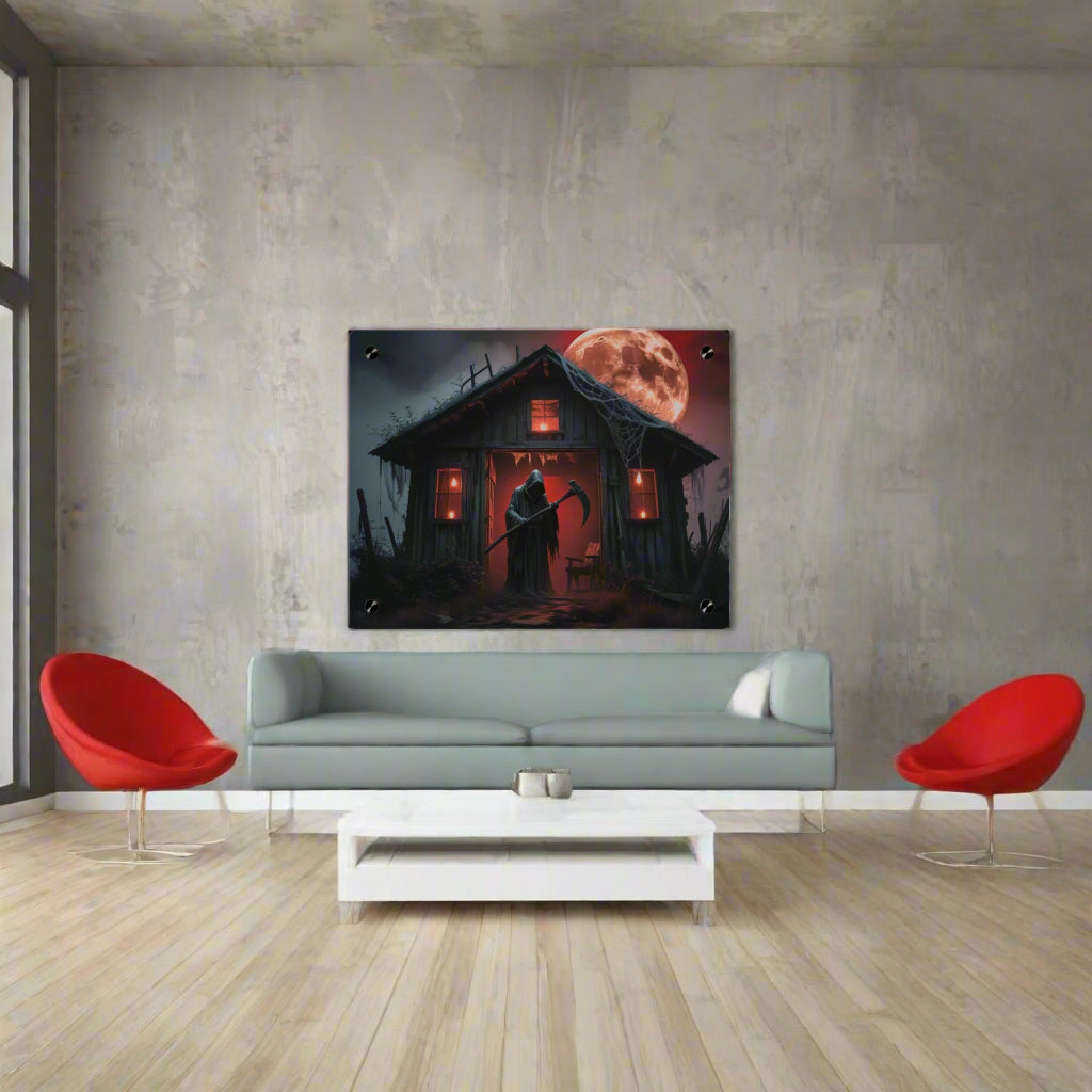 Halloween-themed wall art with a haunted house and full moon on a white wall.