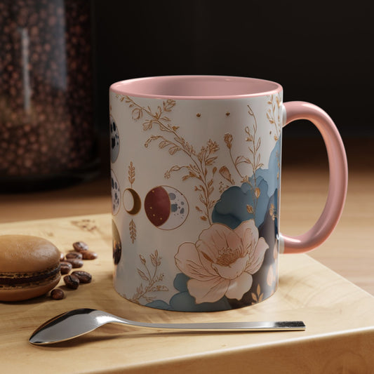 Mug with floral design on a wooden surface with coffee beans and a spoon.
